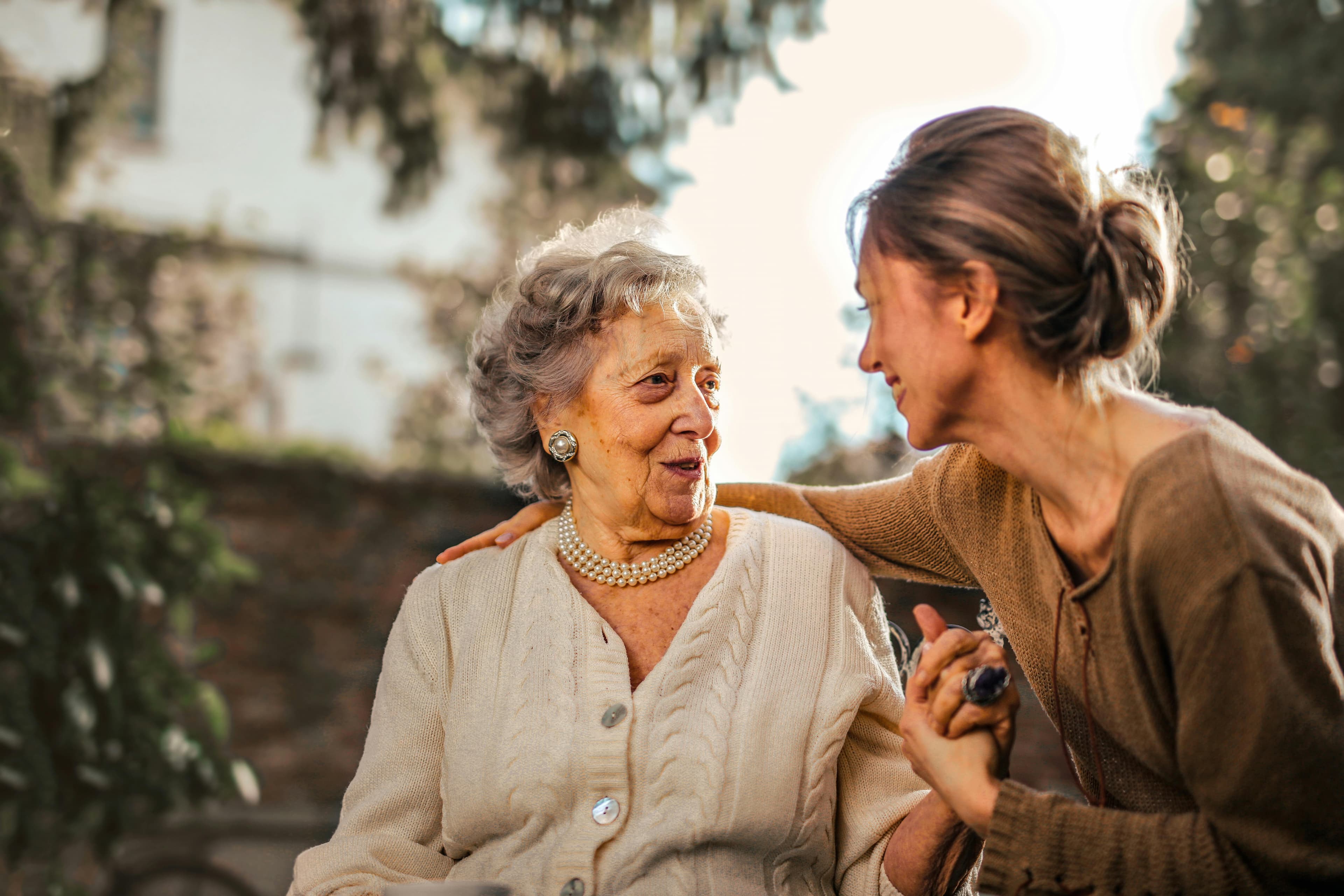 Woman Helping an Elderly Woman